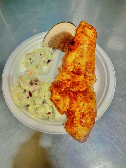Fish fry with coleslaw, potato salad and rye bread